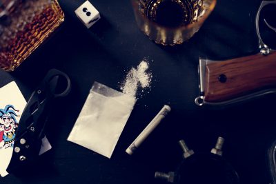 Drugs gun knife on the table