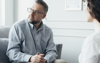 Psychotherapist working with man in office